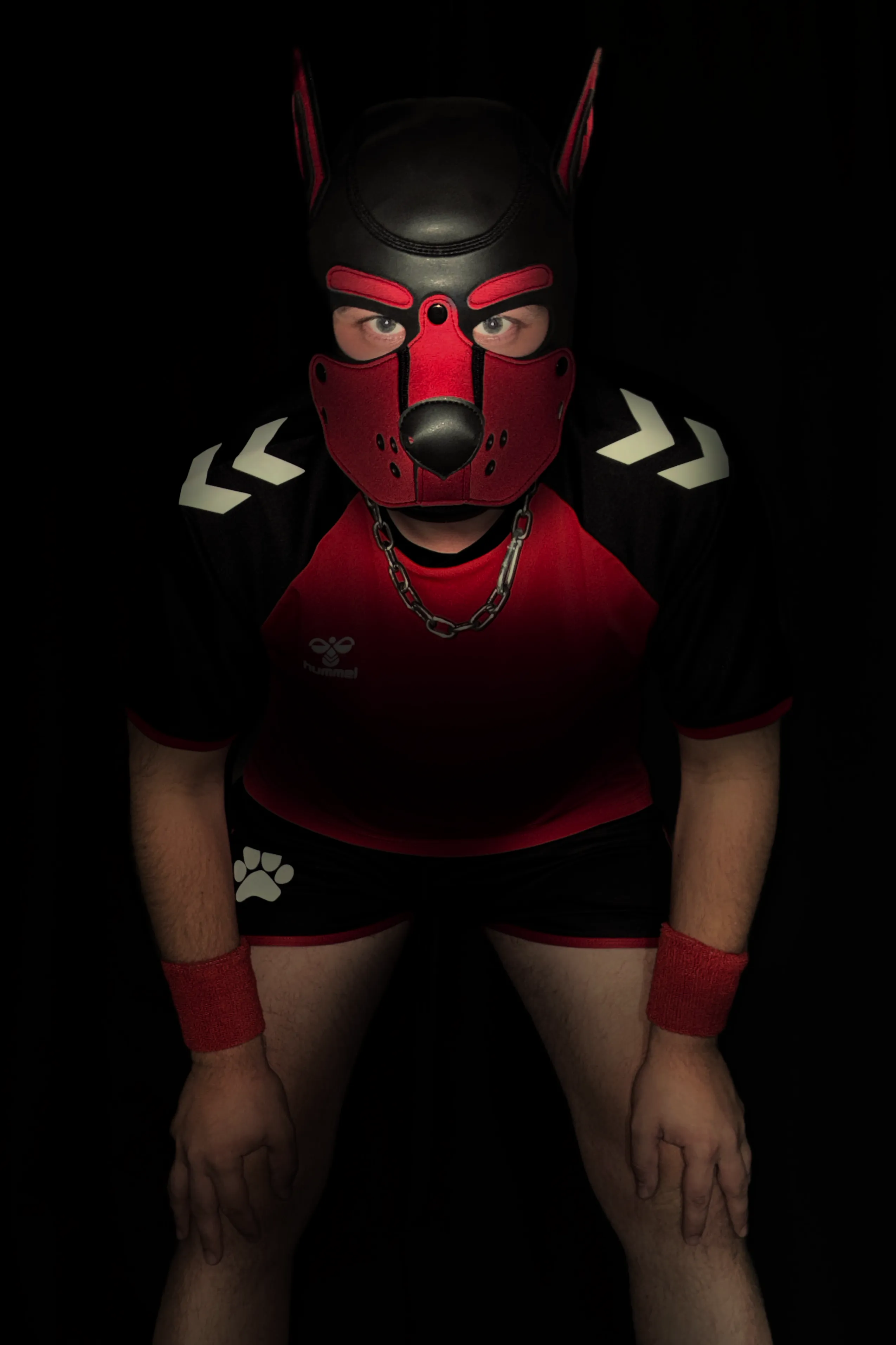Retch wearing a black and red pup hood and athletic jersey